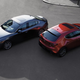 Two Mazda3s perch pristinely in a parking paddock.
